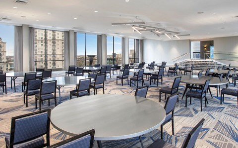 meeting area with round tables and blue chairs
