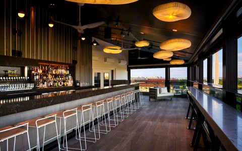 enclosed patio with full bar and seating area with a view of the washington monument