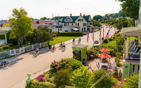 people riding bicycles on the street in front of Harbour View Inn