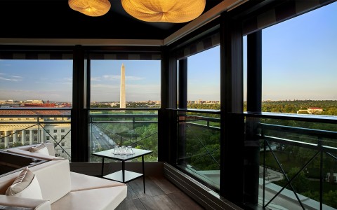 lounge area with white couches and a view of the national monument during the daytime