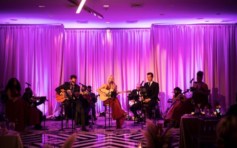 band playing in a purple lighting venue