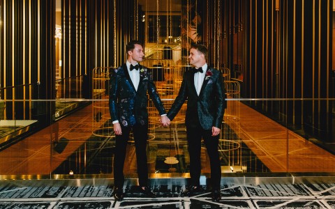 2 grooms holding hands
