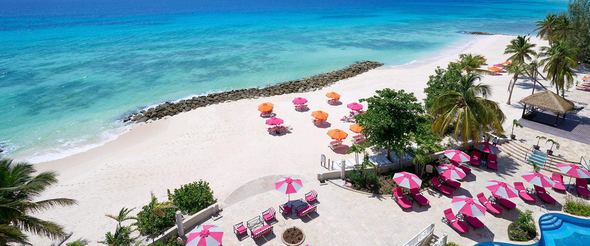 pink sun umbrellas and beach view