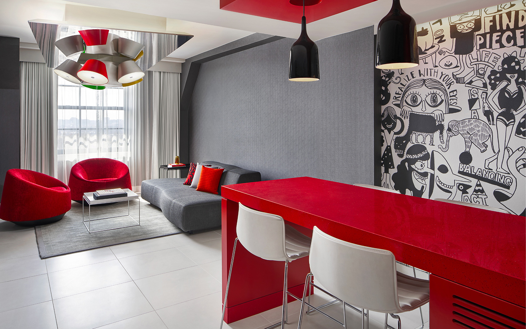 modern lounge area with grey and red accent colors and modern lighting