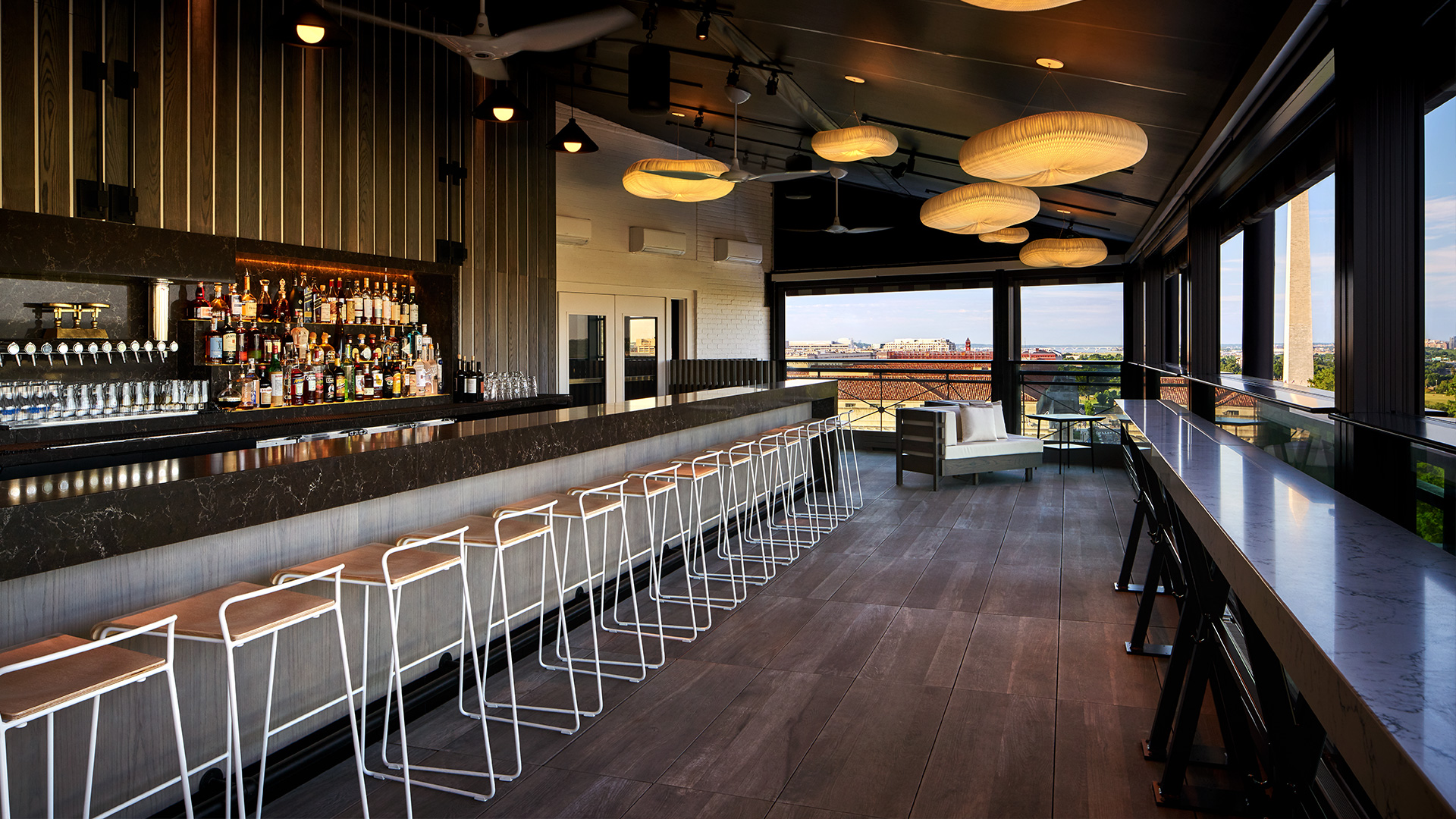 modern bar with cloud like lighting and view of the national monument