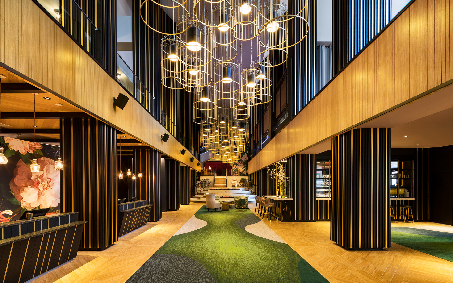 lobby shot with yellow and black walls and long corridor with cylindrical lighting
