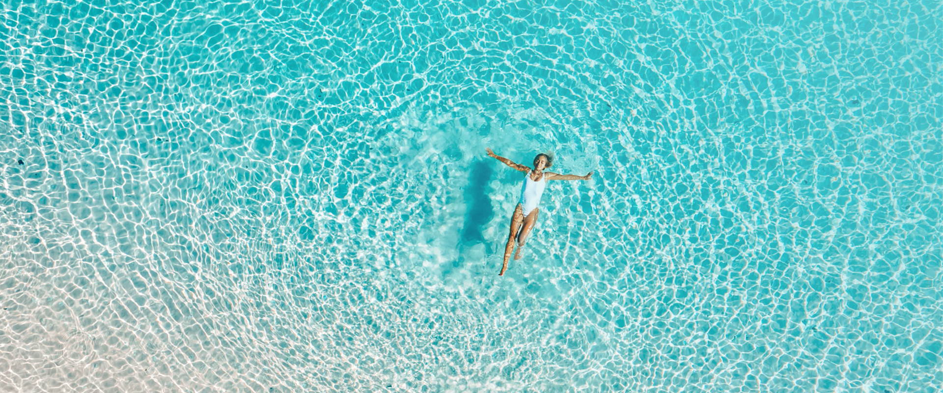 up view of a woman swimming backwards on the ocean