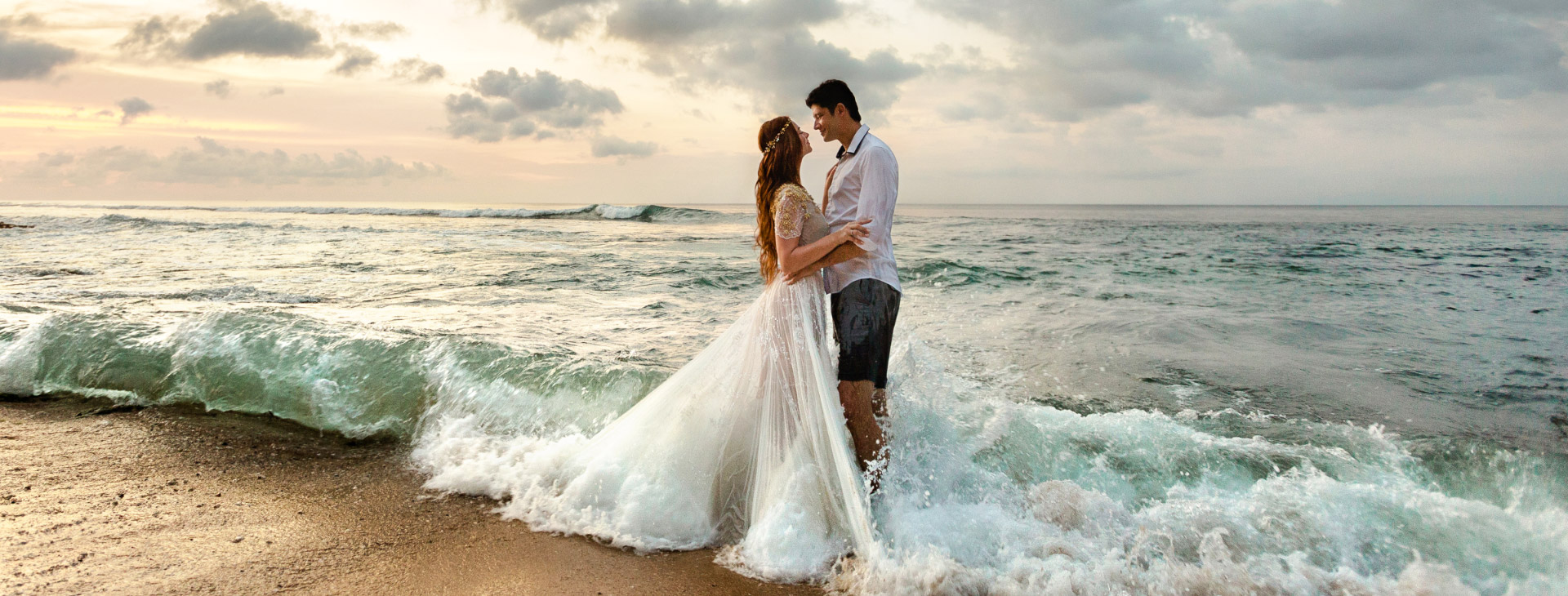 bride and groom hugging on the beach