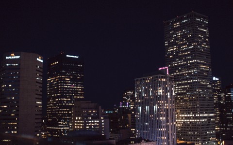 view of a city with the building lights on at night 
