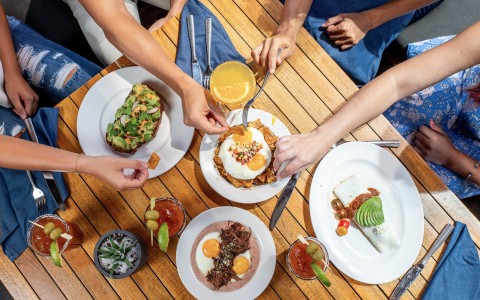 multiple breakfast items and cocktails on a table