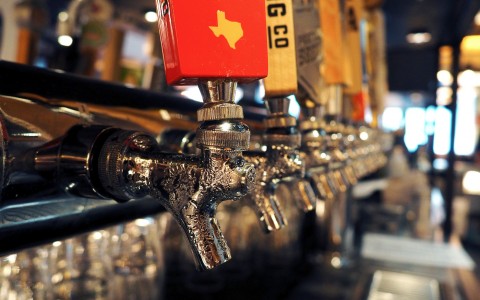 line of beer taps at the bar