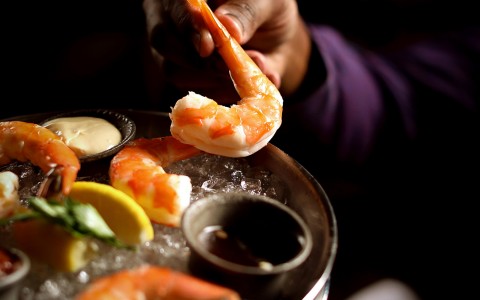 a man grabbing a shrimp