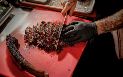 a man cutting a steak
