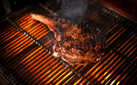 a steak on a fire grill