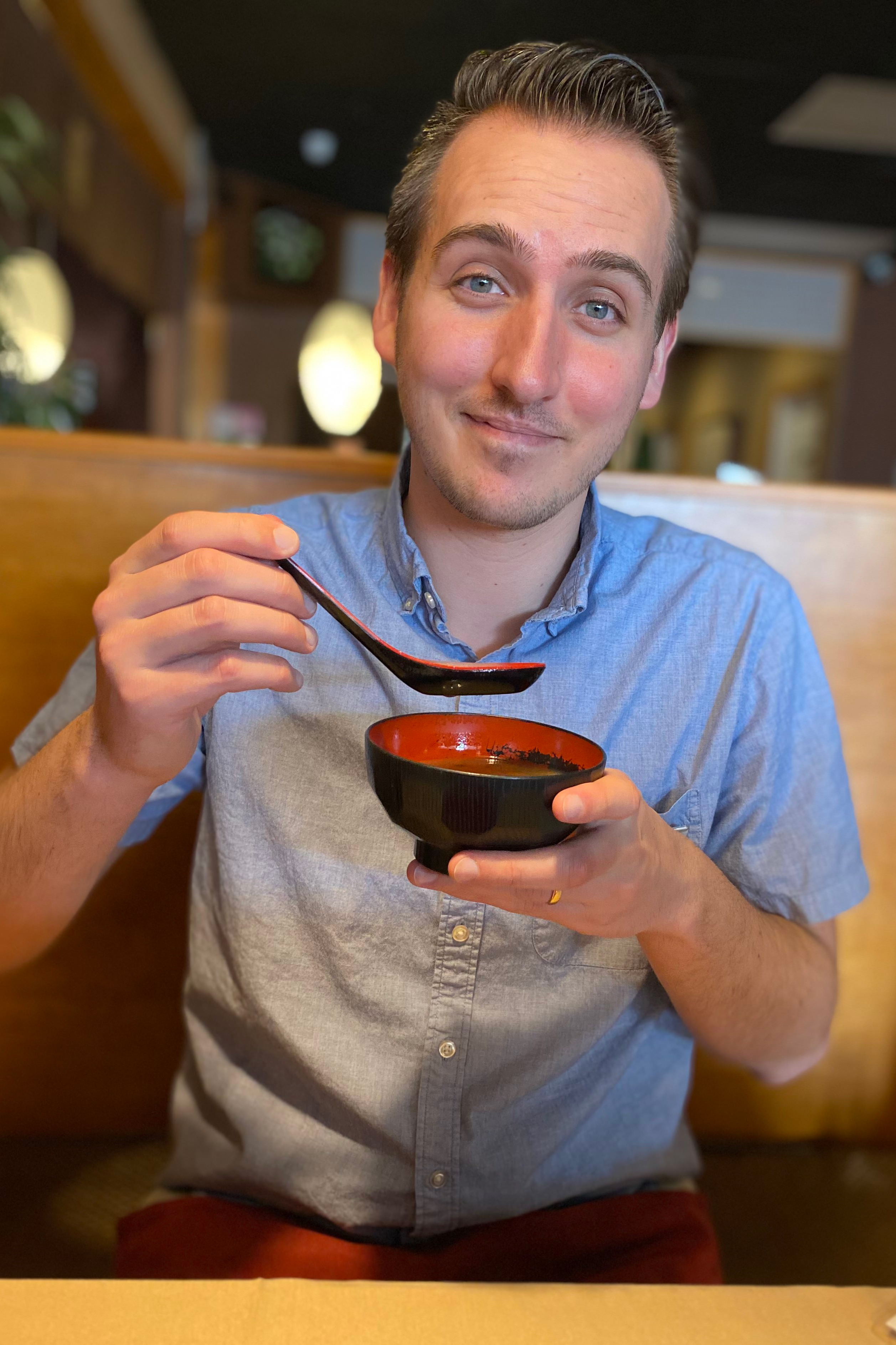 guy eating asian soup