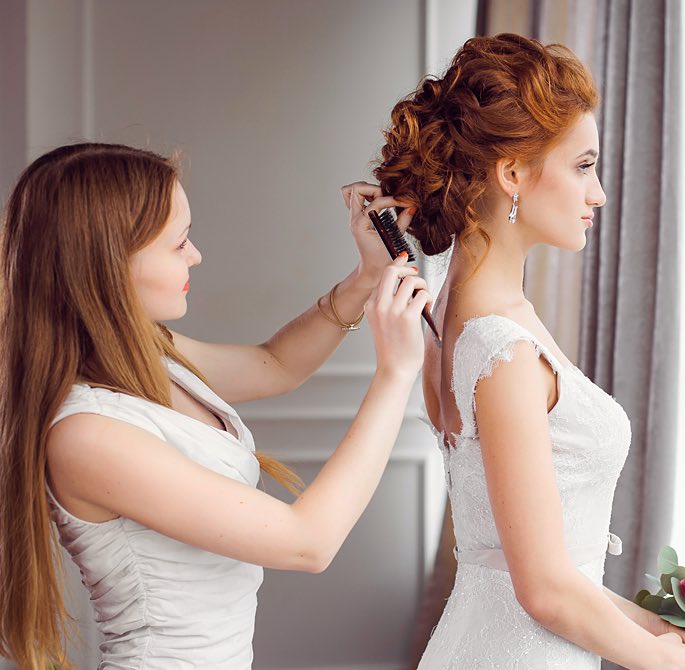 Woman getting her hair done before her wedding