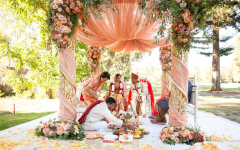 Indian Wedding Ceremony with a colorful arch and beautiful flowers for decor