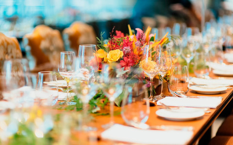 Event dining table set up with colorful flowers in the middle