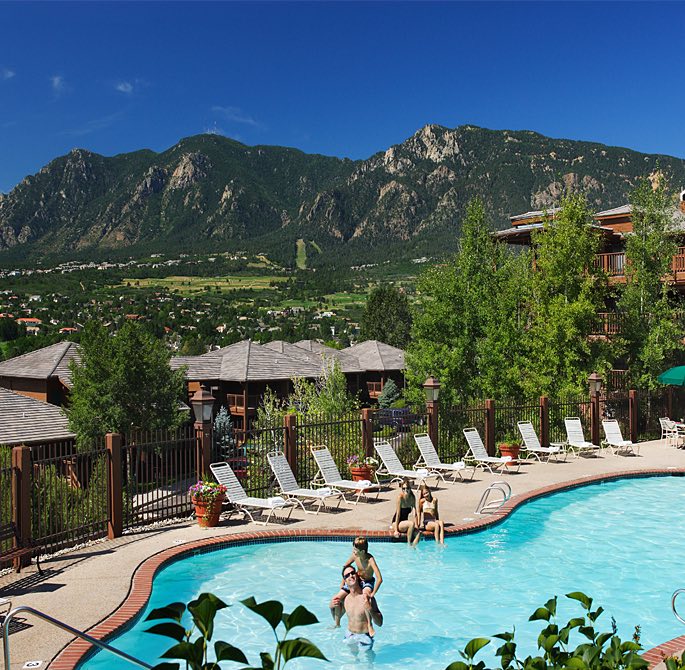 the pool outside the hotel with views of the mountains