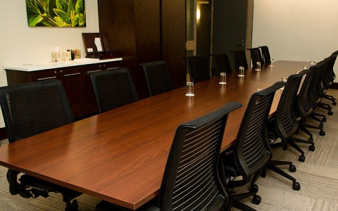 brown wooden table with black chairs