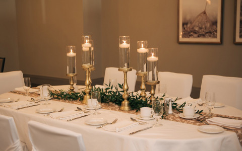 gold candle sticks on a formal dinner table