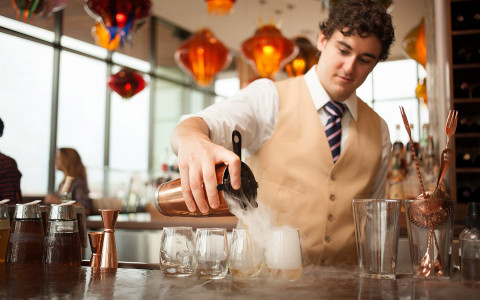 man pouring cocktail in restaurant