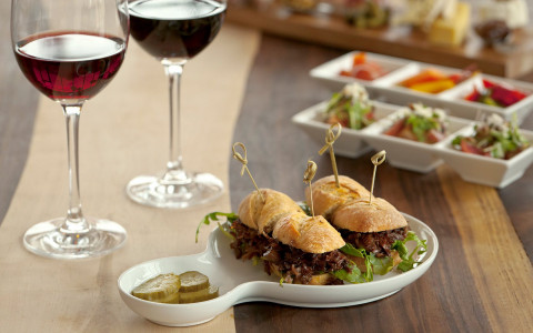 sandwiches on white plate with wine
