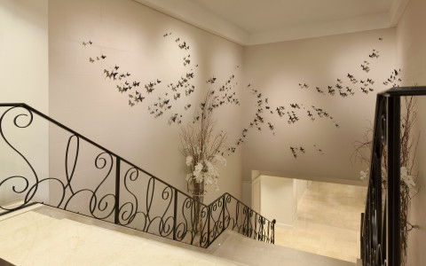 marble staircase with butterflies design on wall