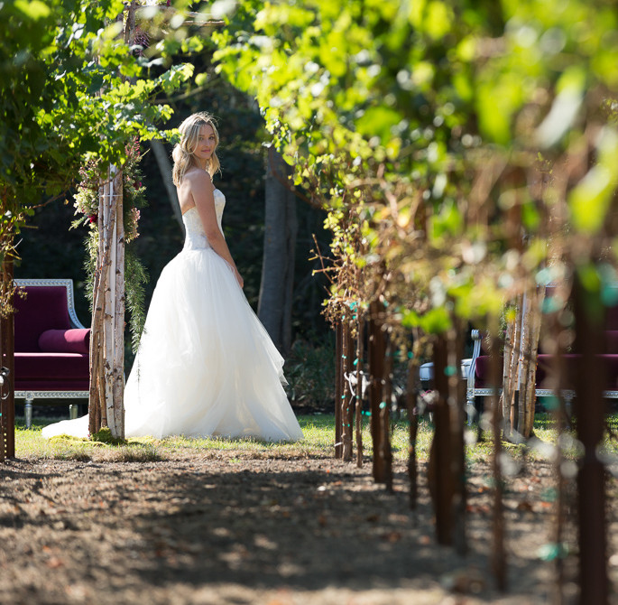 bride standing in the vineyard before her wedding