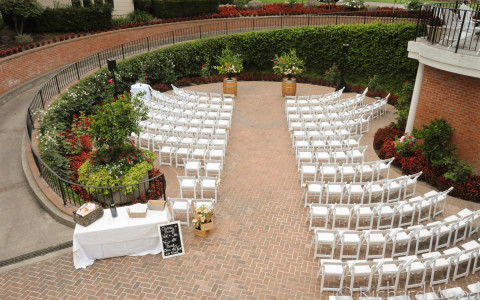 Wedding Ceremony setup at the Arbor location with a beautiful curved walkway from the mansion leading down into the ceremony