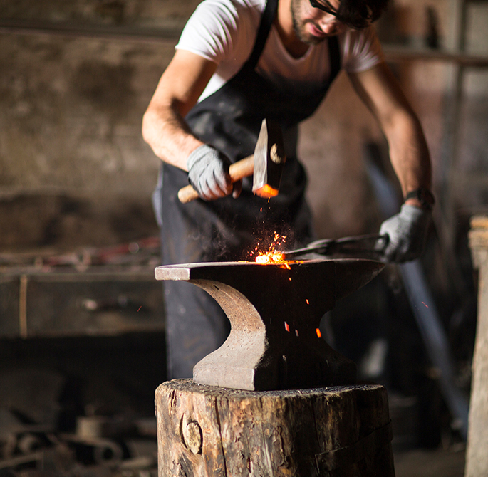 blacksmith forging a small metal piece