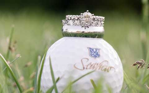 wedding rings on a golf ball with the Seaview logo on it