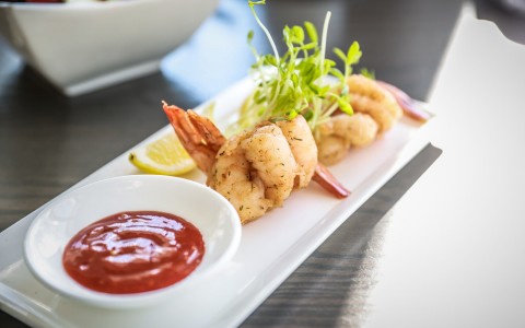 plate of shrimp with cocktail sauce