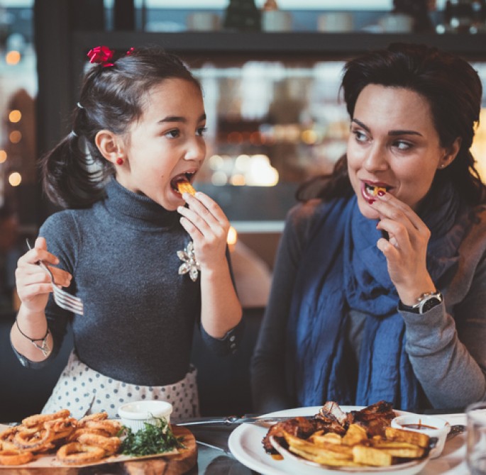 mother and daughter enjoy a meal together 