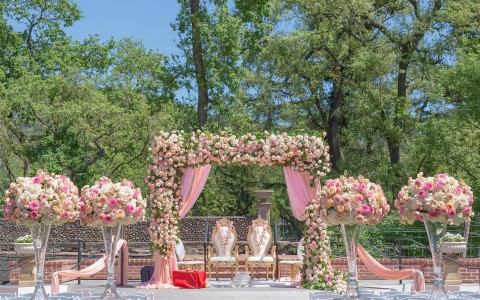exquisite Indian wedding ceremony setup featuring big beautiful bouquets of pink and white toned roses