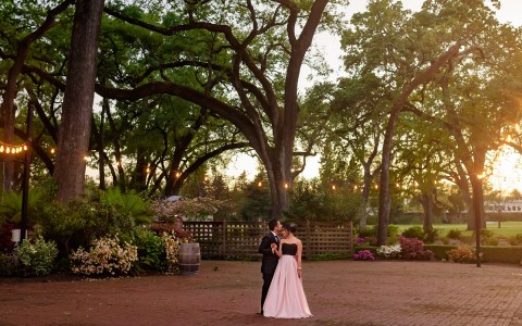 Bride and groom embracing with a gorgeous backdrop of the grove during sunset