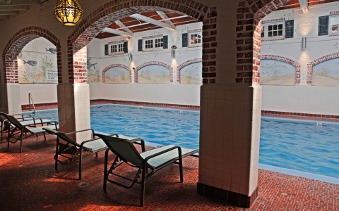 indoor pool with four beach chairs