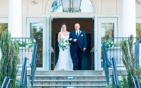 smiling newlyweds on stairs