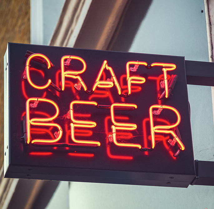 neon banner announcing craft beer