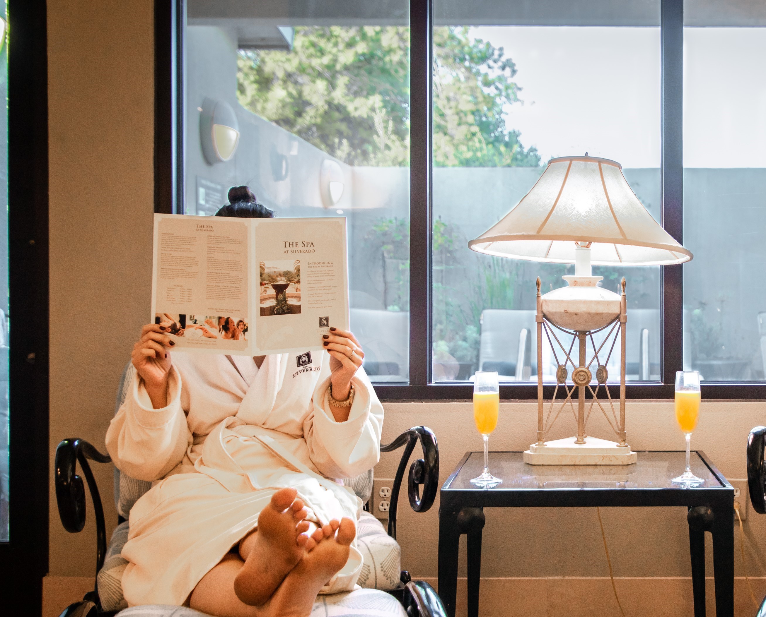resort guest reading treatments and services of the spa