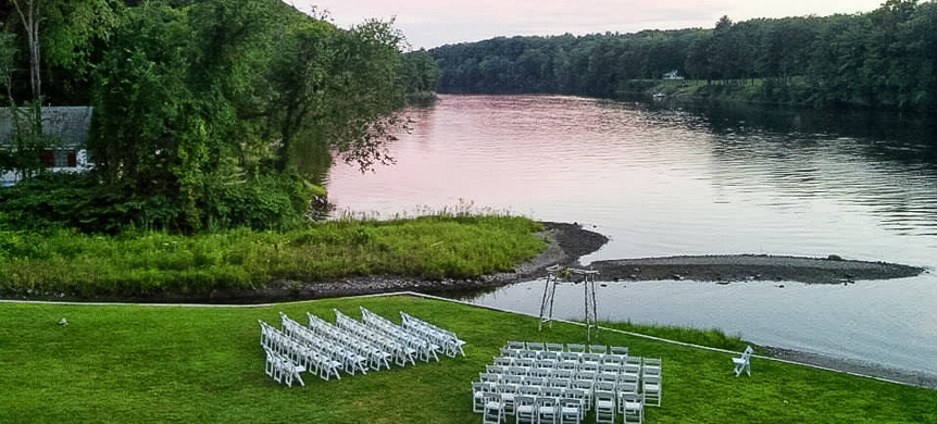 chairs set by a lake for a wedding