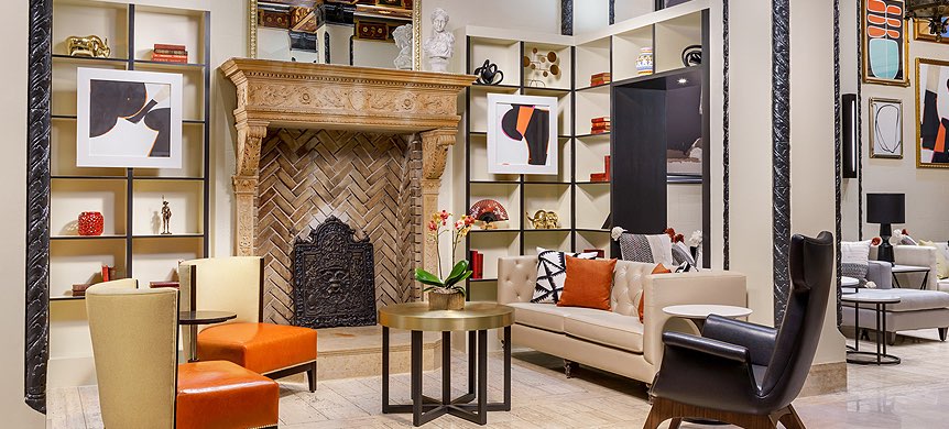Modern lobby area with orange pop color and fireplace