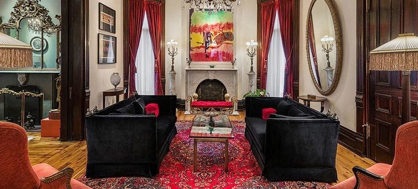 Living space with fireplace and red curtains on windows