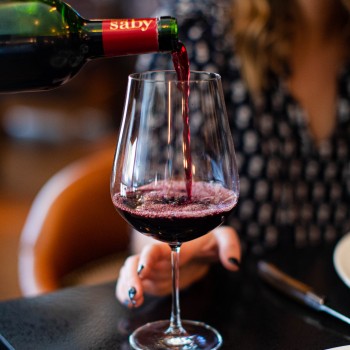 Woman getting wine from server