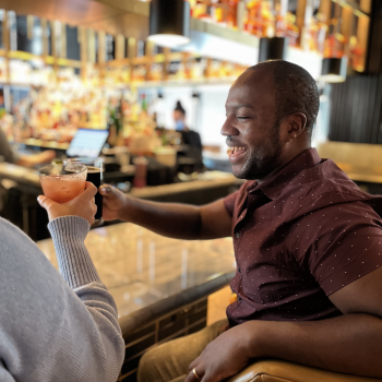 man cheers at Acre bar