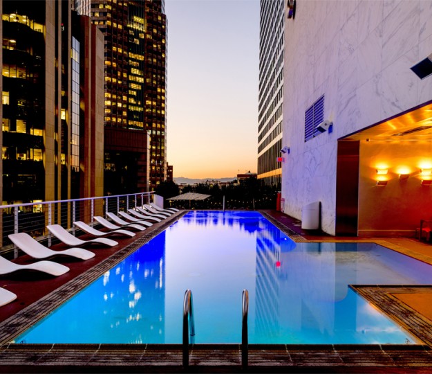 pool and lounge chairs at sunset