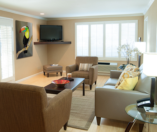 room living area with couch, chairs, coffee table, and flat screen tv and large french doors
