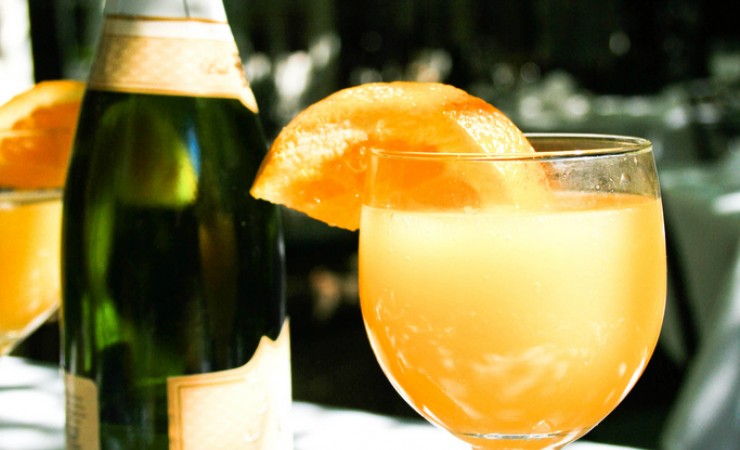 Mimosa glass and bottle of champagne