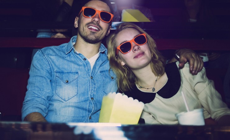 couple in orange glasses at movie theater