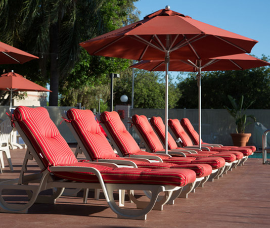 Airtel pool read cushion lounge chairs and umbrellas
